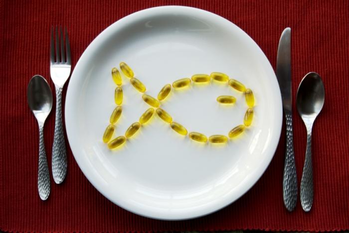 Fish oil supplements on a dinner plate