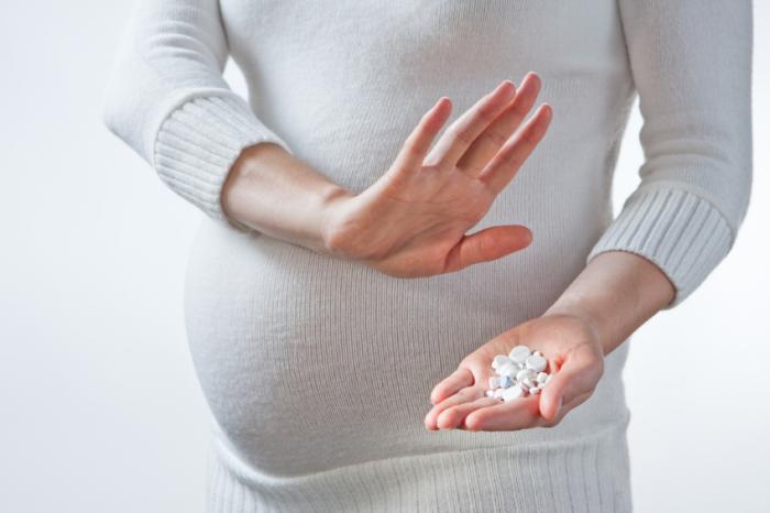 pregnant woman with pills