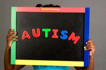 child holding autism sign