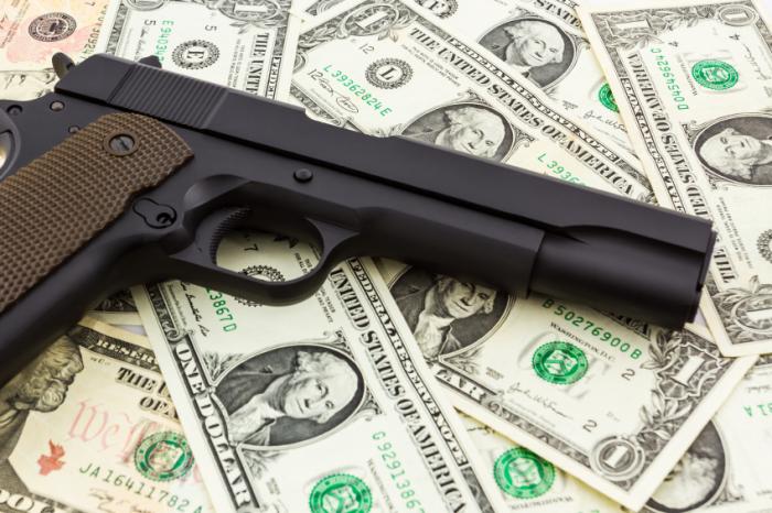 gun and dollar bills