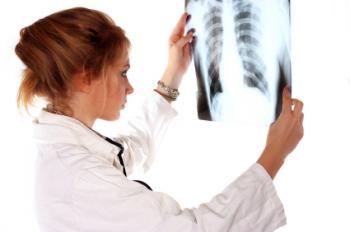 clinician inspecting x-ray