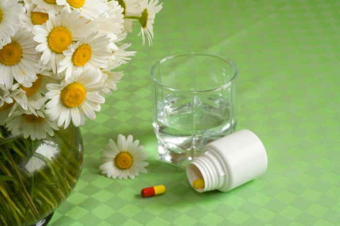 Antihistamines with flowers and a glass of water.