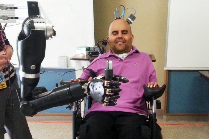 Erik Sorto controlling the robotic arm with his mind