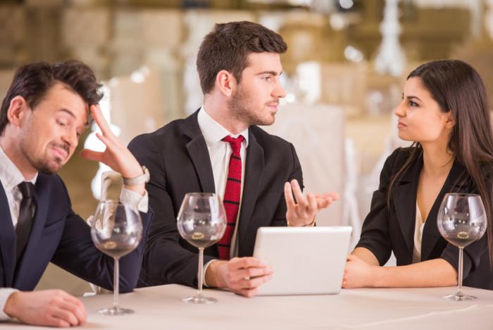 Man excluded from conversation at dinner.