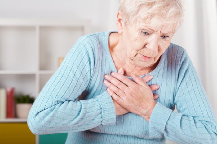 Senior woman having a heart attack.