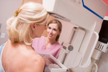 Woman having a mammogram with a clinician.