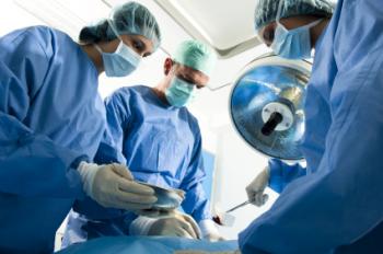 Surgeons operating on a patient in theater.