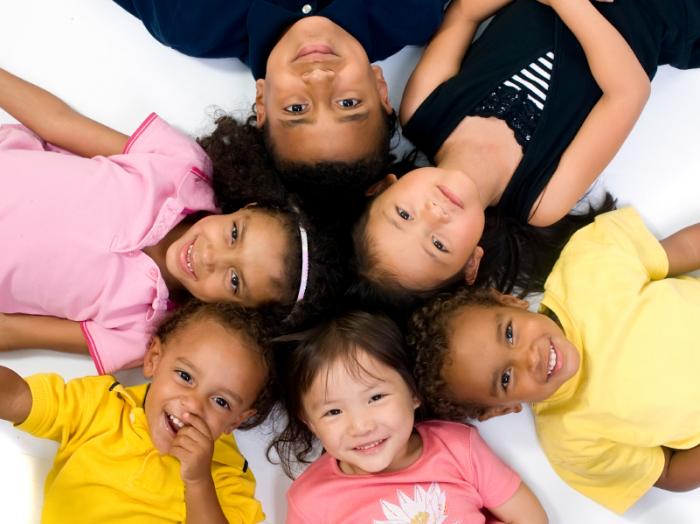 smiling children lying in a circle