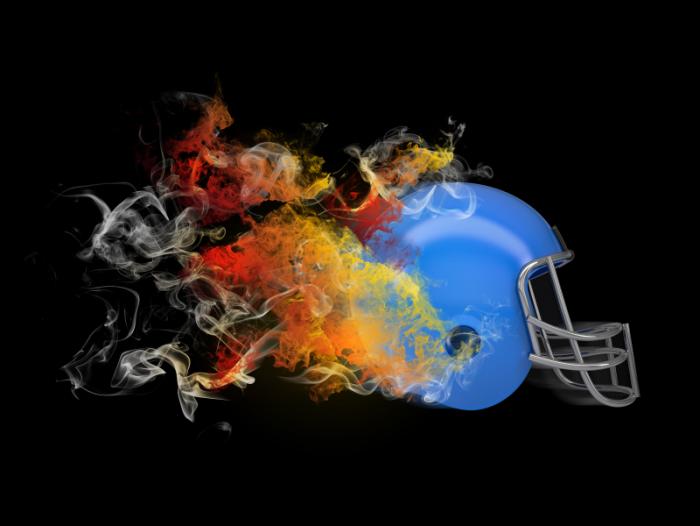 An American football helmet with flames coming out of it.
