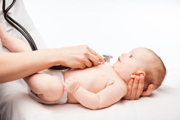 A baby is being examined by a doctor with a stethoscope.
