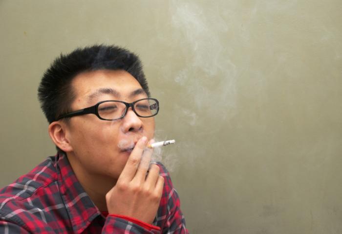 [A Chinese man smoking]