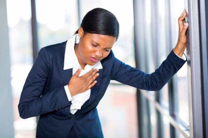 A woman is experiencing chest pain.