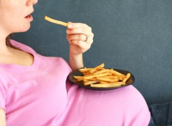[A pregnant woman eating fries]