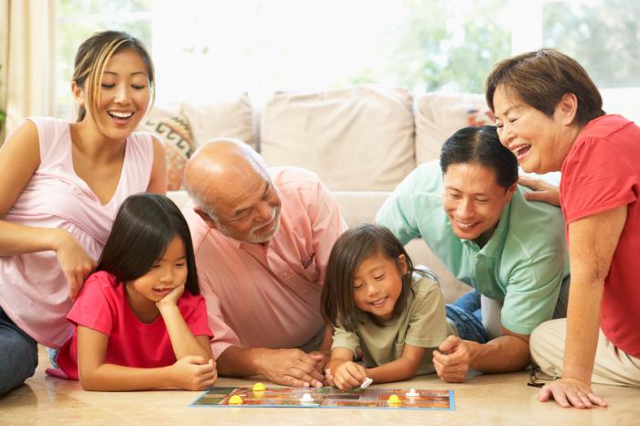 [A family playing a board game]