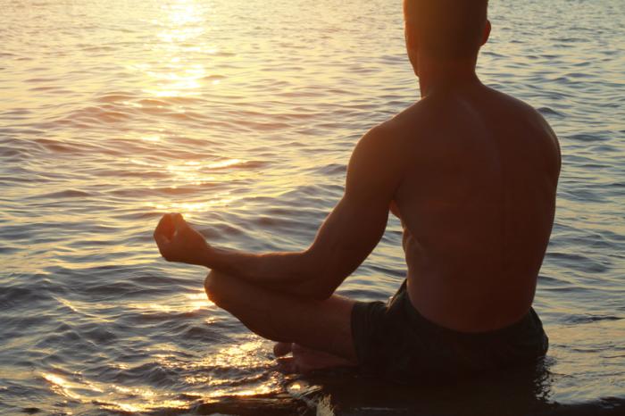 [A man meditating by the sea]