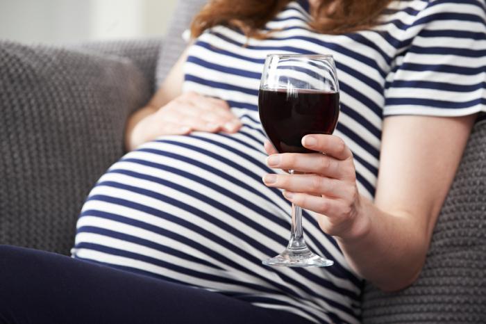 [Pregnant woman drinking wine]