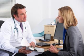 male doctor talks to female patient