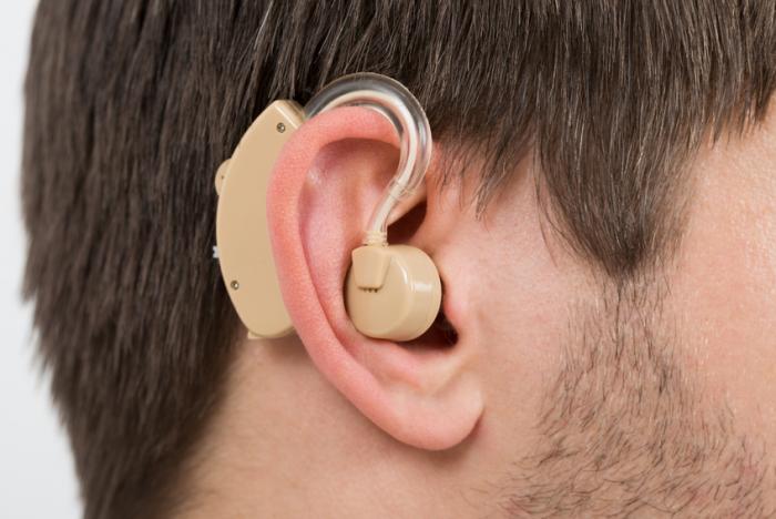[Man wearing a hearing aid]