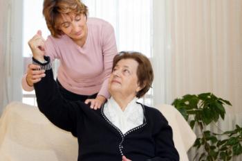 carer helping patient move arm