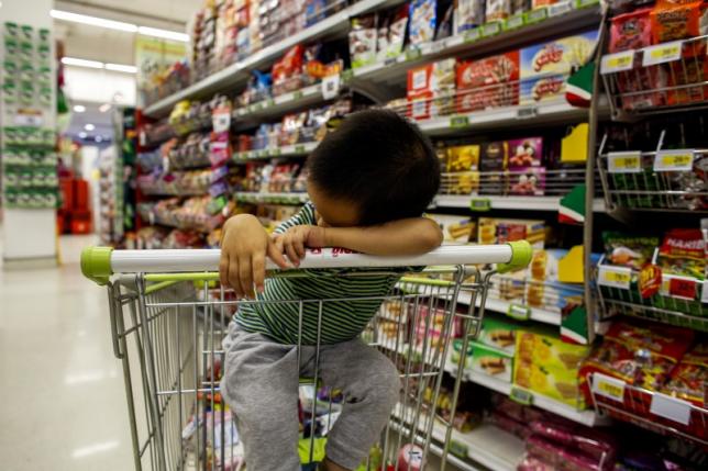 A boy sleeps in a shopping cart at a department store in Bangkok October 29, 2013. REUTERS/Athit Perawongmetha